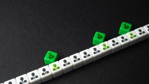 Ilustração com cubos representando trabalhadores e blocos verdes com símbolo de dinheiro, simbolizando o pagamento do abono salarial PIS/PASEP.